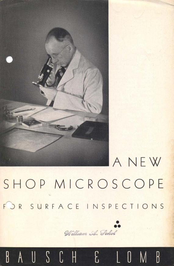 A person looking through a microscope
Description automatically generated