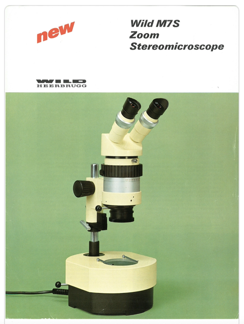 A white microscope with black lenses
Description automatically generated