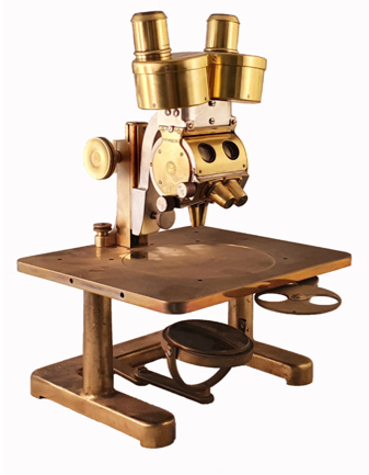 A gold and silver microscope
Description automatically generated